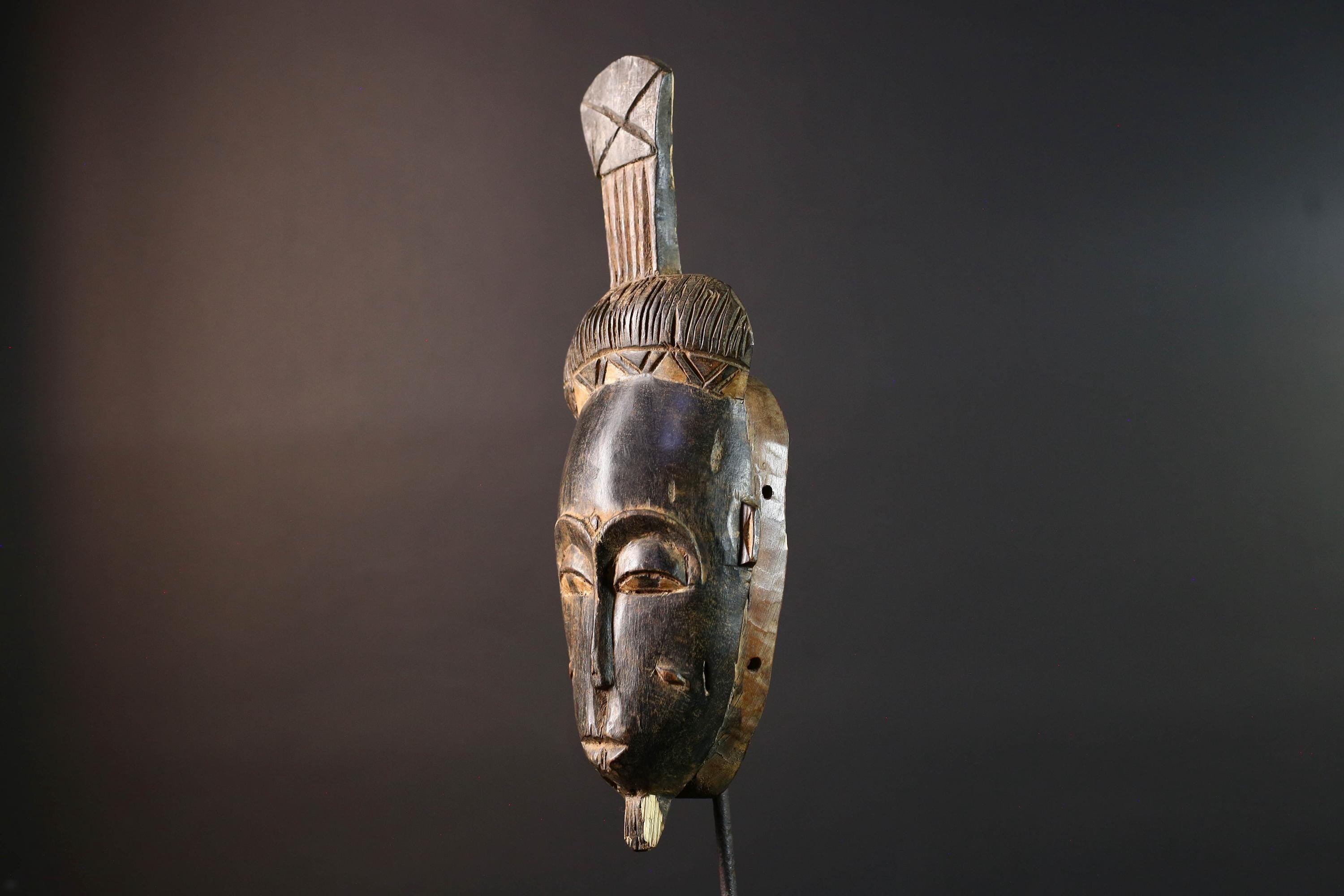 Africa tribal wall mask Baule carving with tall ridged crest narrow face and symbolic cheek marks for spiritual interior statement art G5502