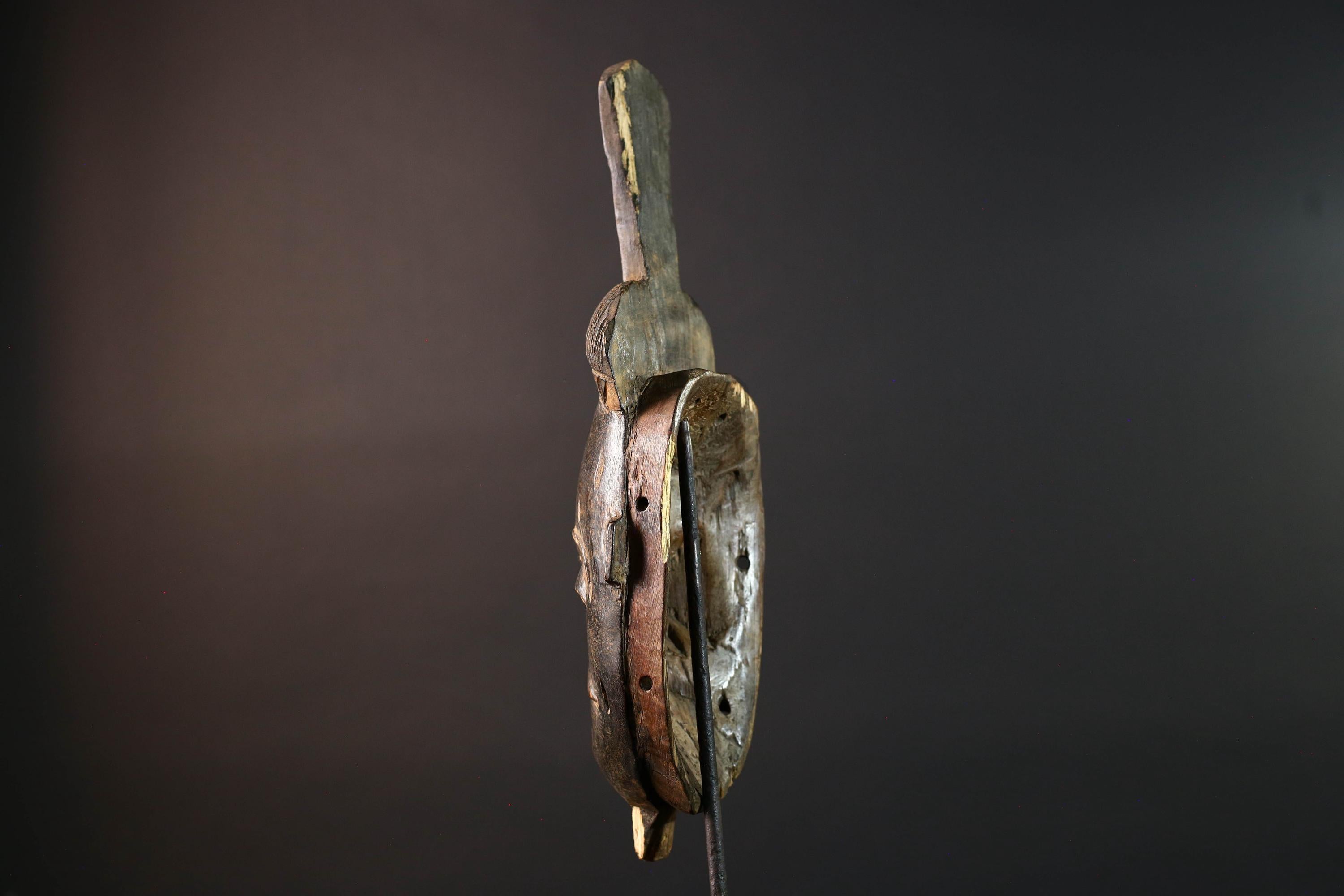 Africa tribal wall mask Baule carving with tall ridged crest narrow face and symbolic cheek marks for spiritual interior statement art G5502