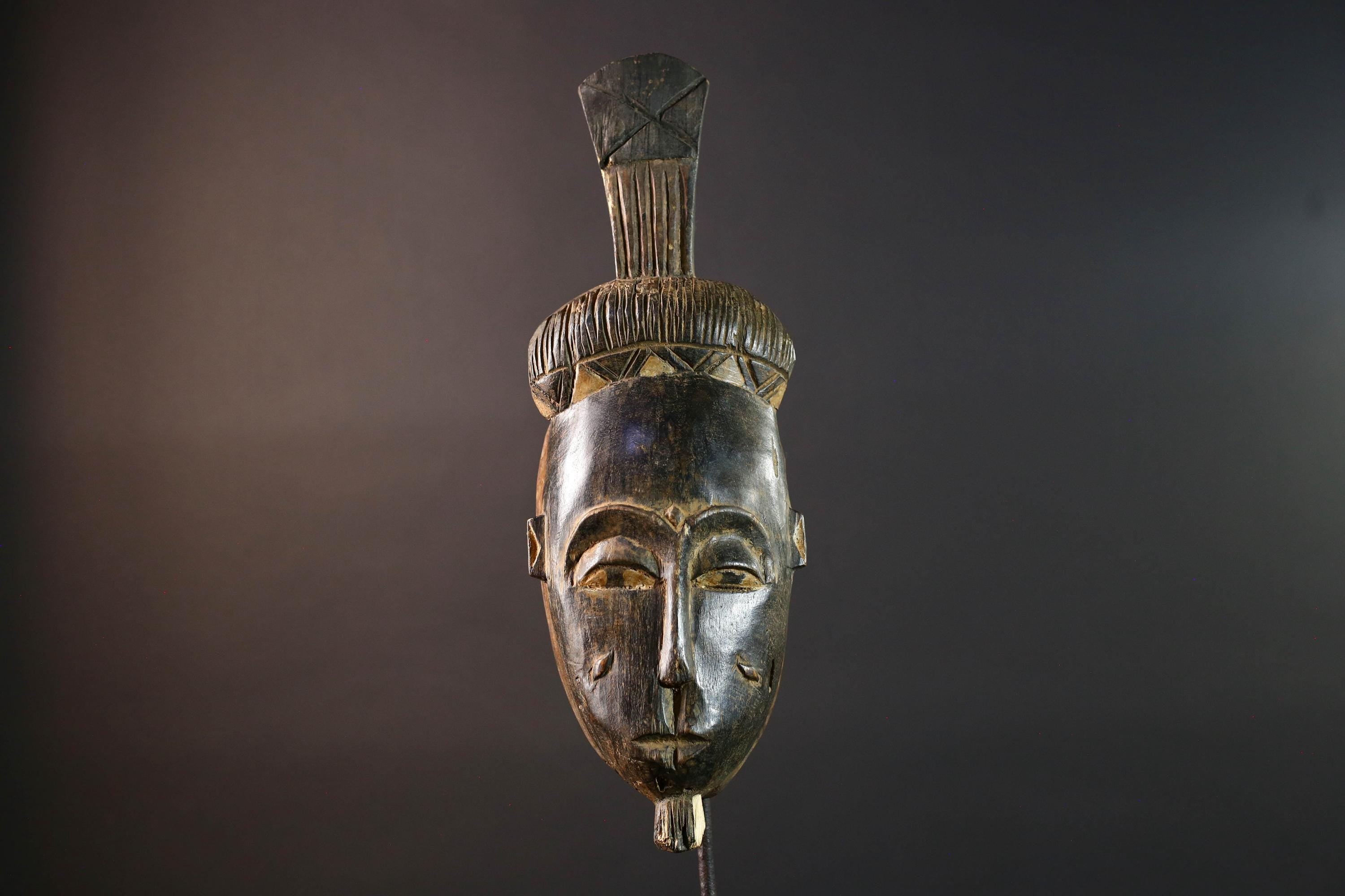 Africa tribal wall mask Baule carving with tall ridged crest narrow face and symbolic cheek marks for spiritual interior statement art G5502