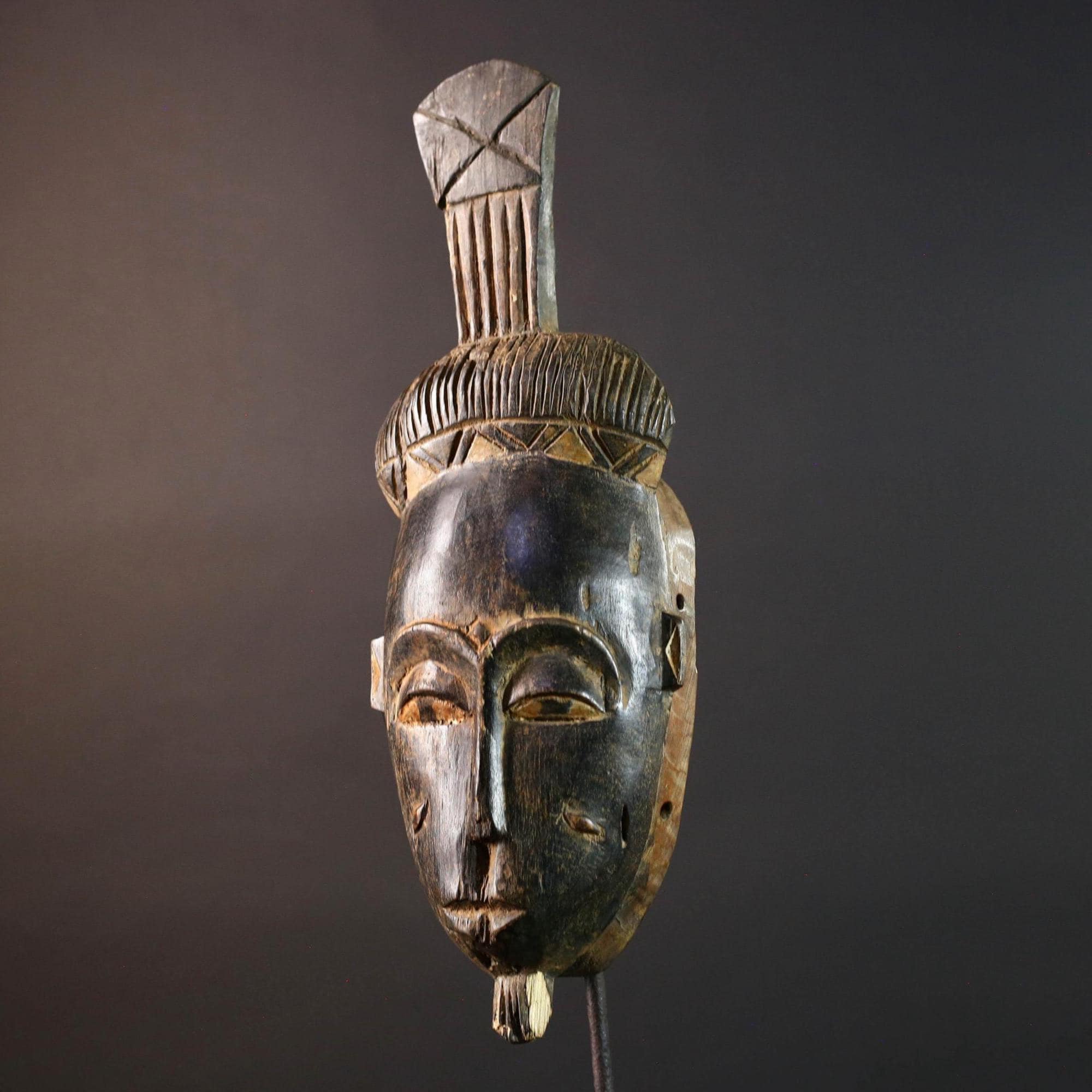 Africa tribal wall mask Baule carving with tall ridged crest narrow face and symbolic cheek marks for spiritual interior statement art G5502