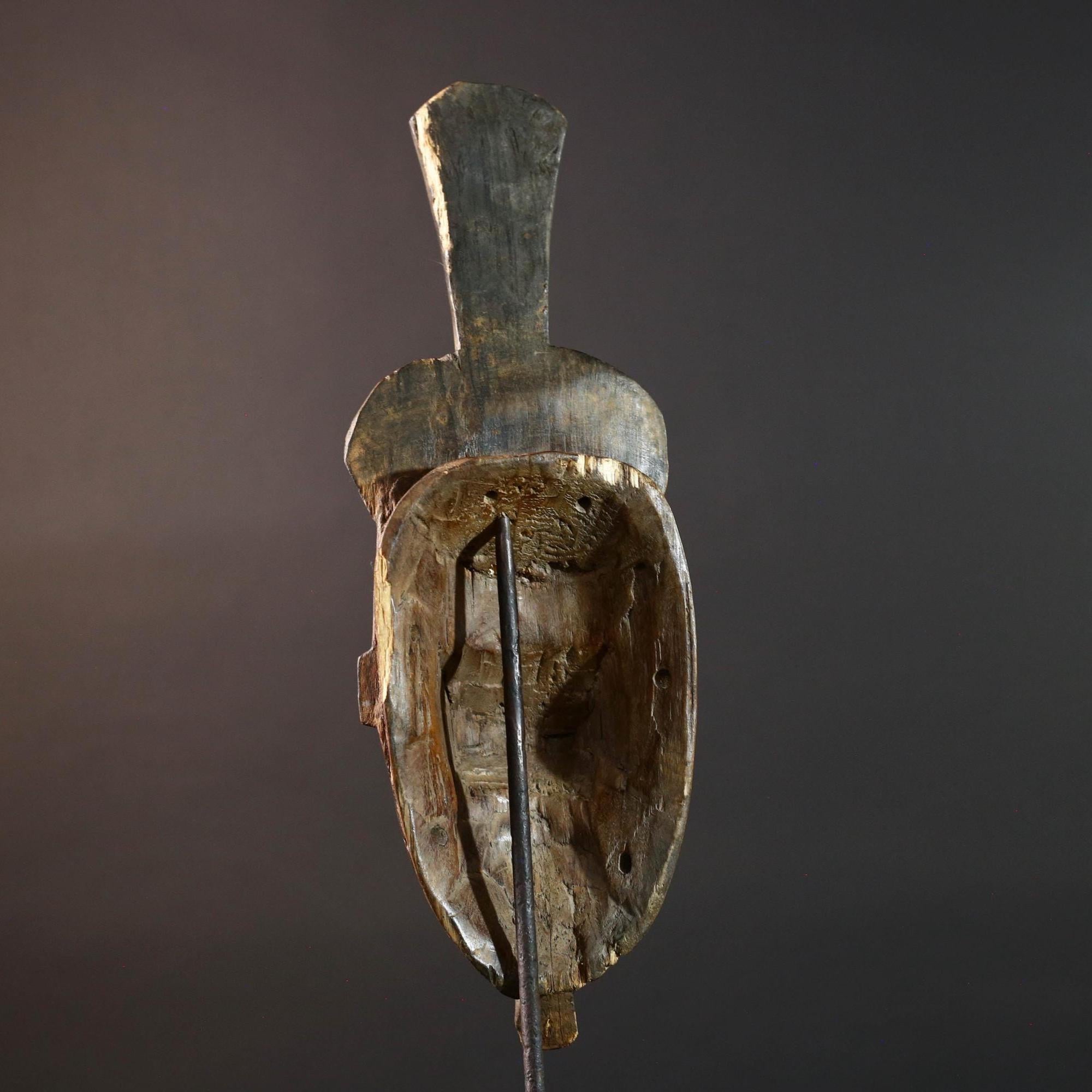 Africa tribal wall mask Baule carving with tall ridged crest narrow face and symbolic cheek marks for spiritual interior statement art G5502