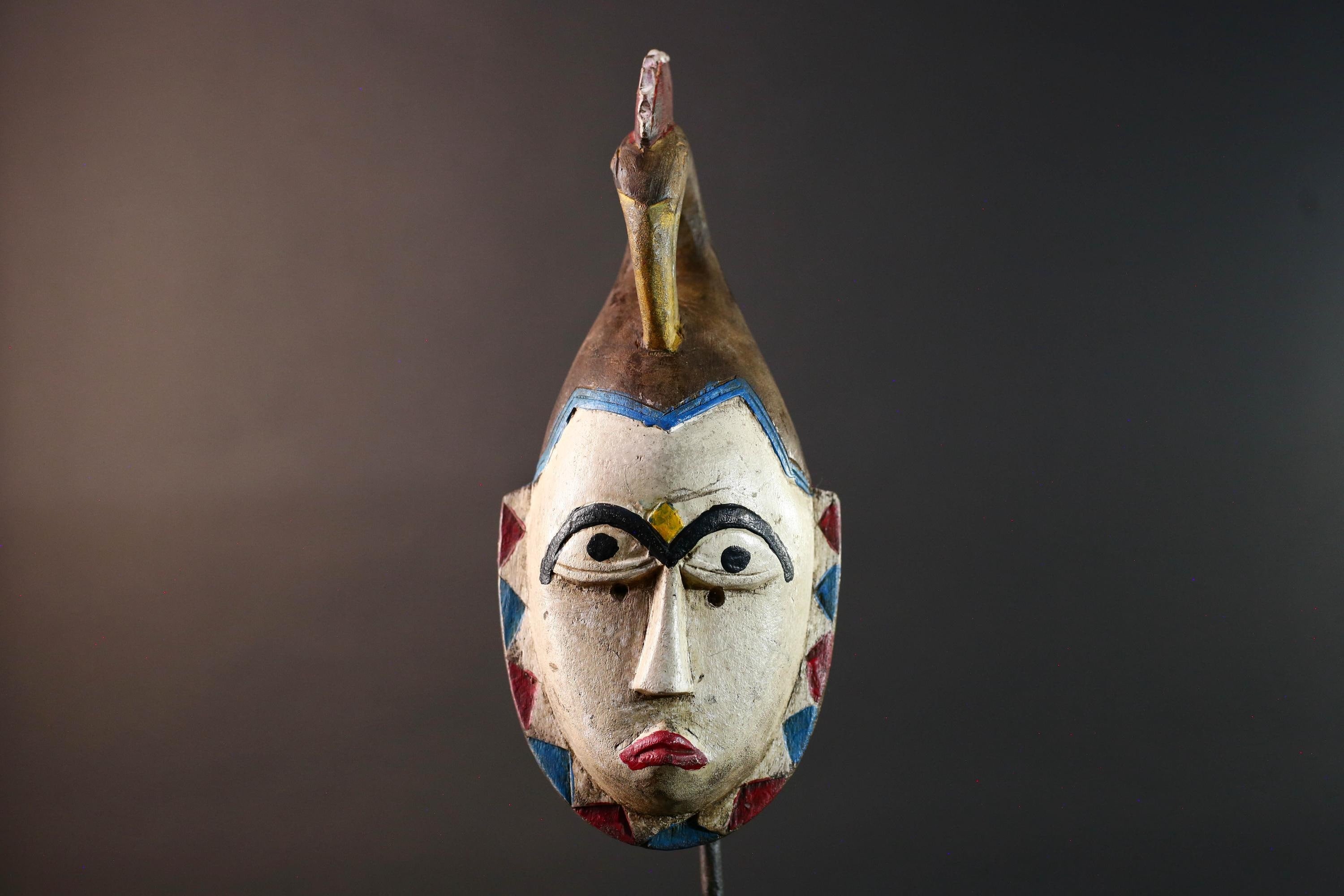 African tribal mask Guro carved wood wall decor with pale face red lips arched brow animal crest artisan symbolic ethnic sculpture-G5519