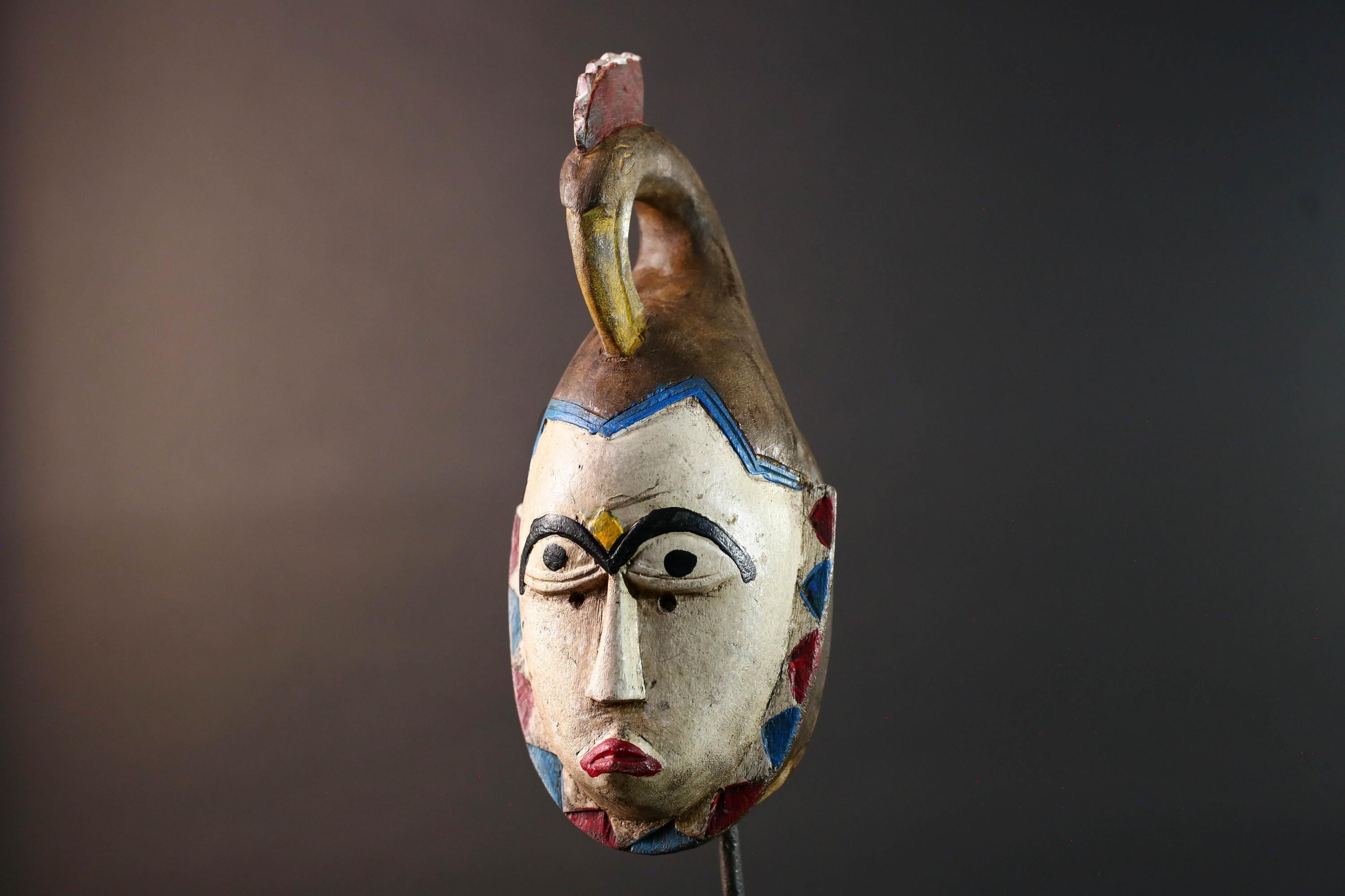 African tribal mask Guro carved wood wall decor with pale face red lips arched brow animal crest artisan symbolic ethnic sculpture-G5519