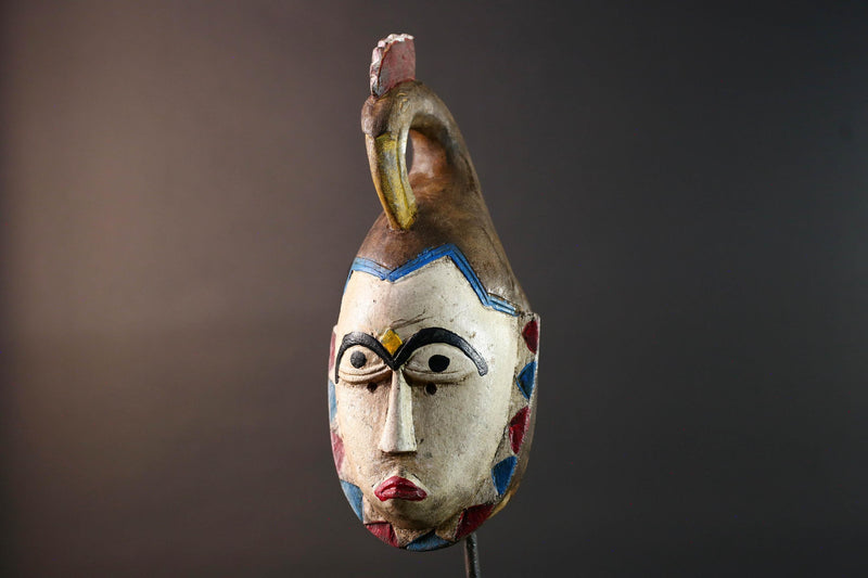 African tribal mask Guro carved wood wall decor with pale face red lips arched brow animal crest artisan symbolic ethnic sculpture-G5519