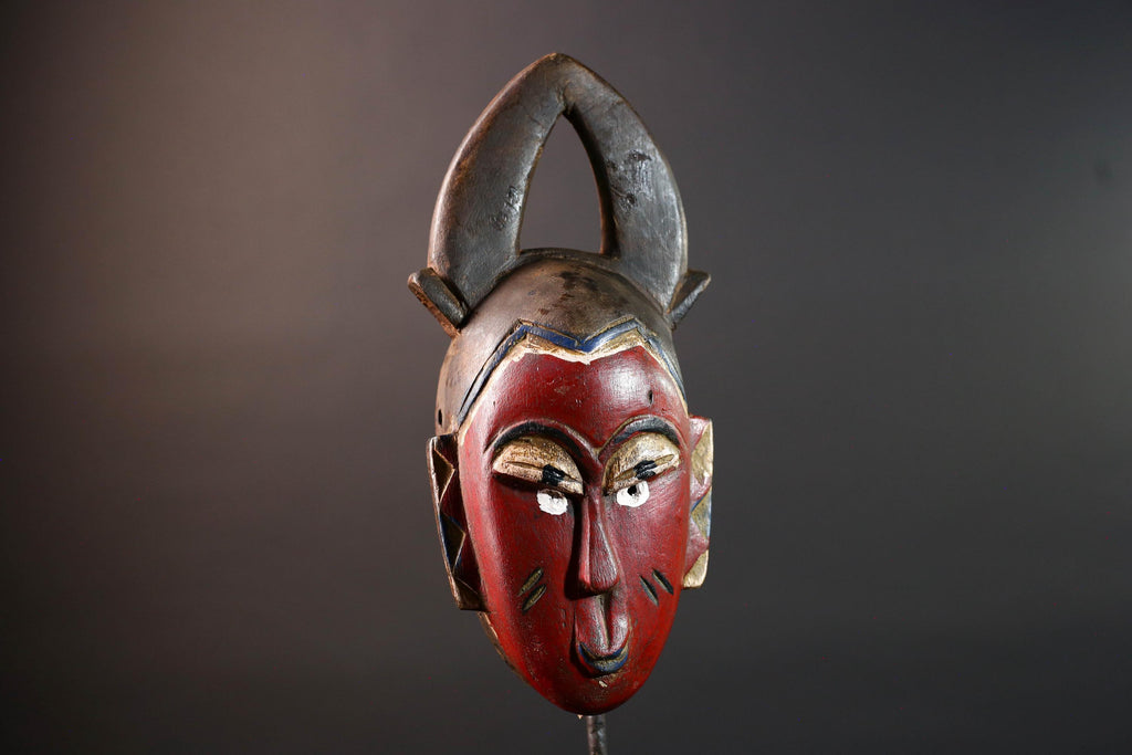 African tribal mask Guro carved wood wall decor with red face double horn crest stylized eyes artisan figure symbolic ethnic art-G5518