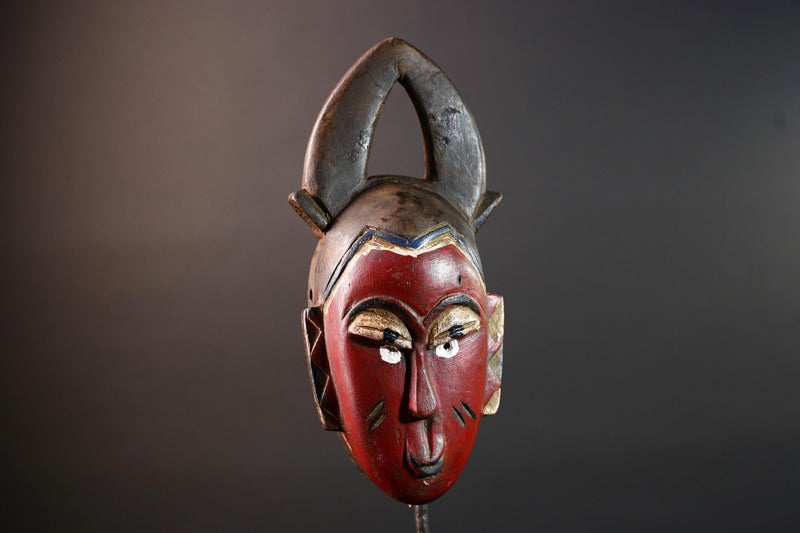 African tribal mask Guro carved wood wall decor with red face double horn crest stylized eyes artisan figure symbolic ethnic art-G5518