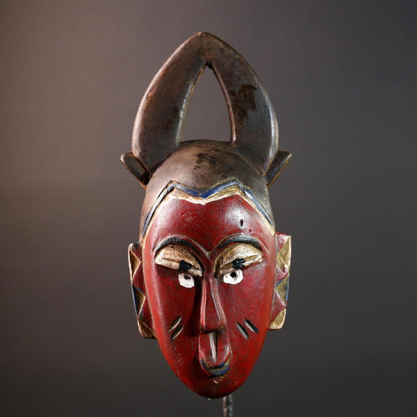 African tribal mask Guro carved wood wall decor with red face double horn crest stylized eyes artisan figure symbolic ethnic art-G5518