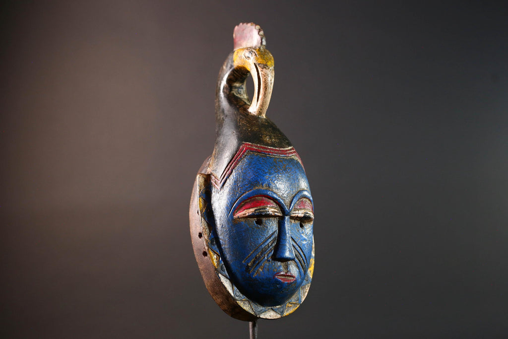 African tribal mask Guro carved wood wall decor with blue face bird crest scarification red white eyelids artisan symbolic sculpture-G5517