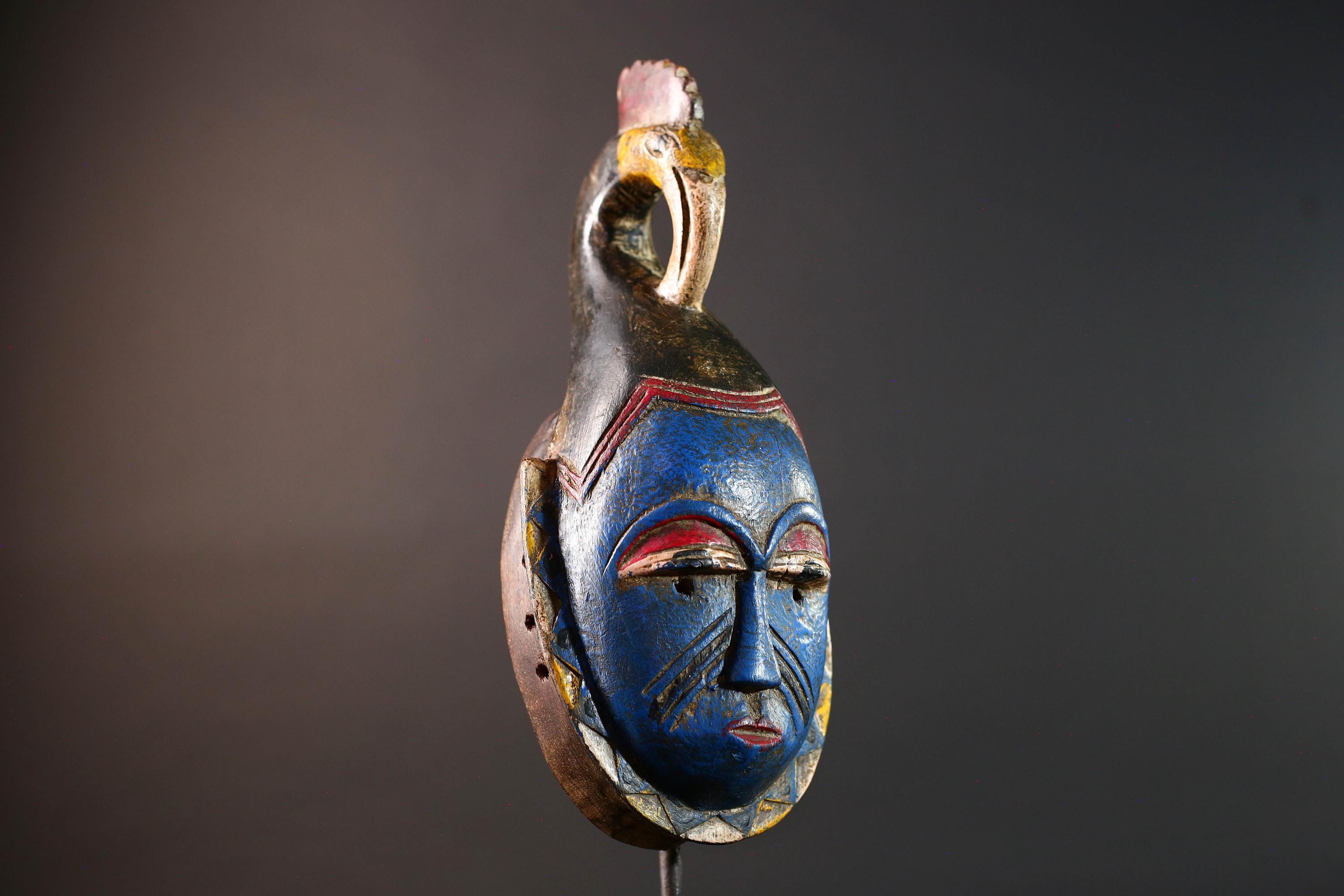 African tribal mask Guro carved wood wall decor with blue face bird crest scarification red white eyelids artisan symbolic sculpture-G5517