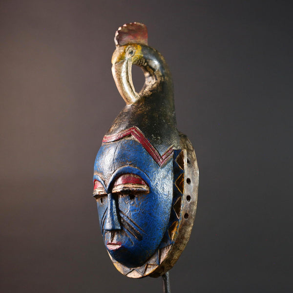African tribal mask Guro carved wood wall decor with blue face bird crest scarification red white eyelids artisan symbolic sculpture-G5517