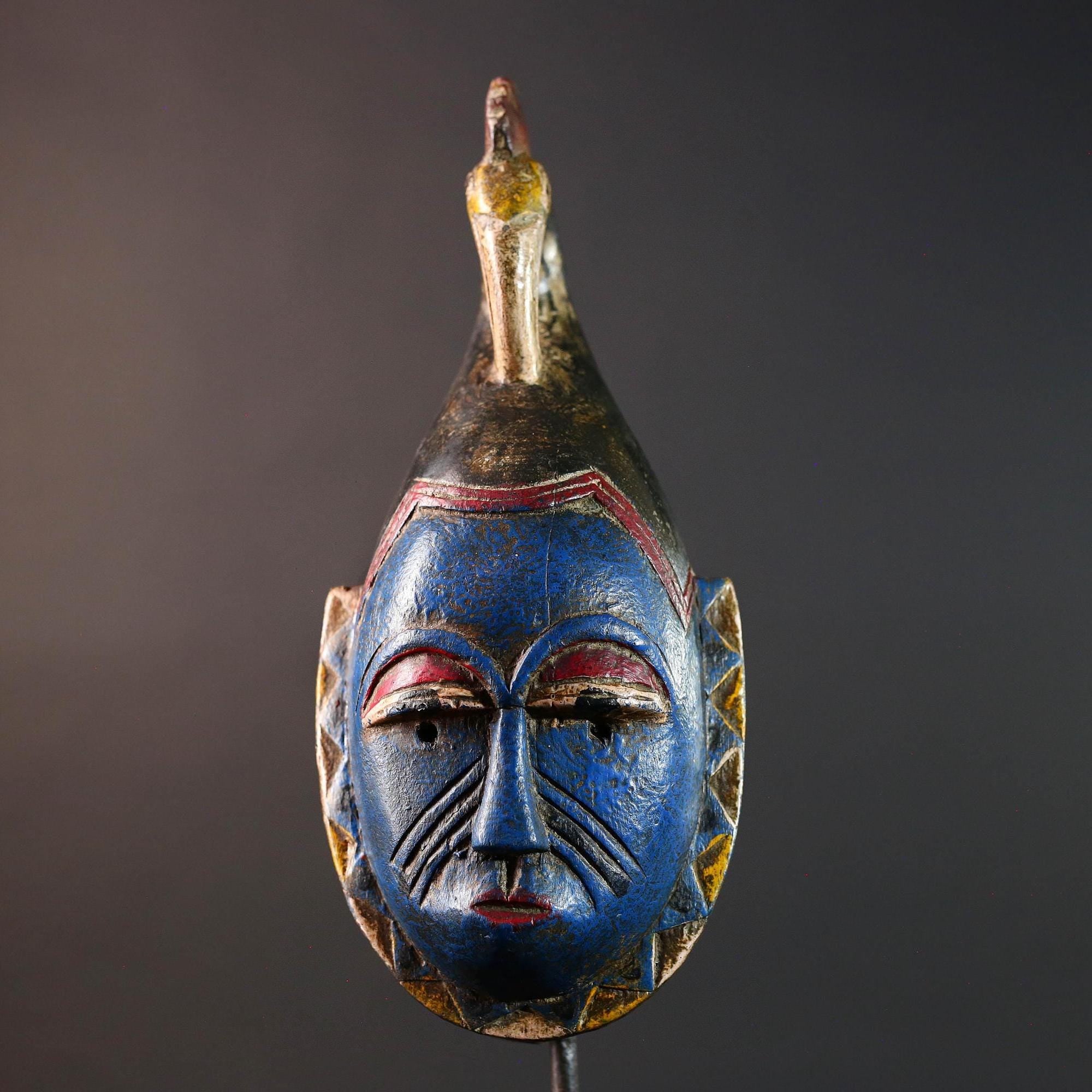 African tribal mask Guro carved wood wall decor with blue face bird crest scarification red white eyelids artisan symbolic sculpture-G5517