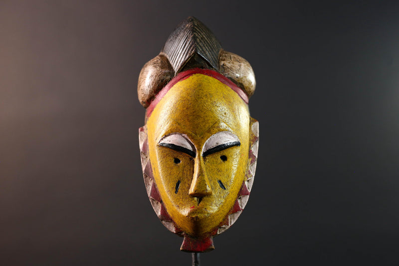 African mask Baule tribe yellow face carved wood with almond eyes rounded side buns geometric cheeks and central crest wall decor-G5539