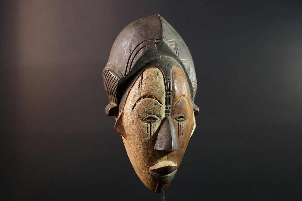 Hand carved African Punu mask tribal wall decor with kaolin white face and tall braided crest art from Central Africa G5569