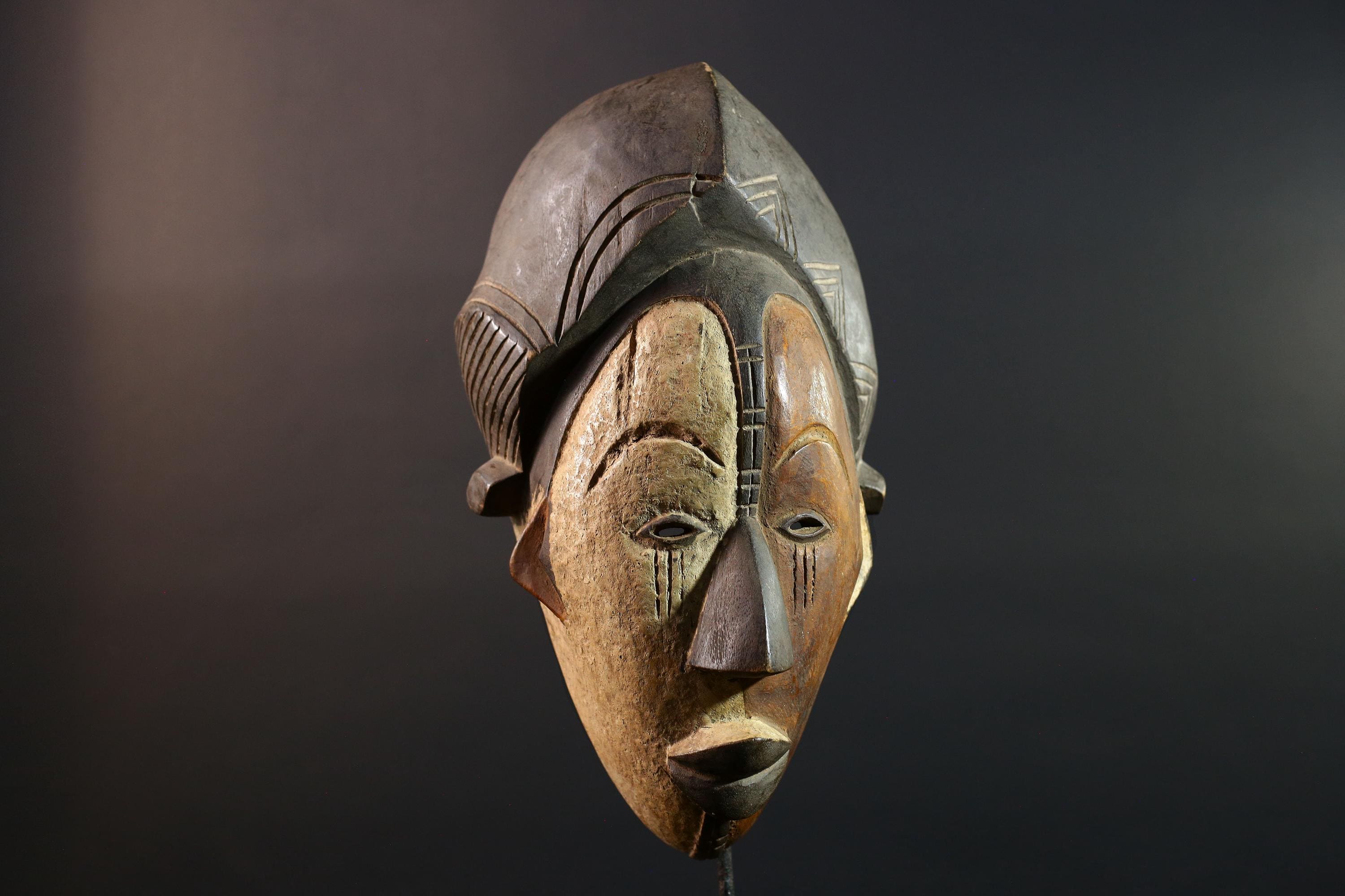 Hand carved African Punu mask tribal wall decor with kaolin white face and tall braided crest art from Central Africa G5569