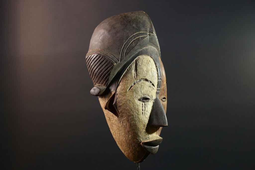 Hand carved African Punu mask tribal wall decor with kaolin white face and tall braided crest art from Central Africa G5569