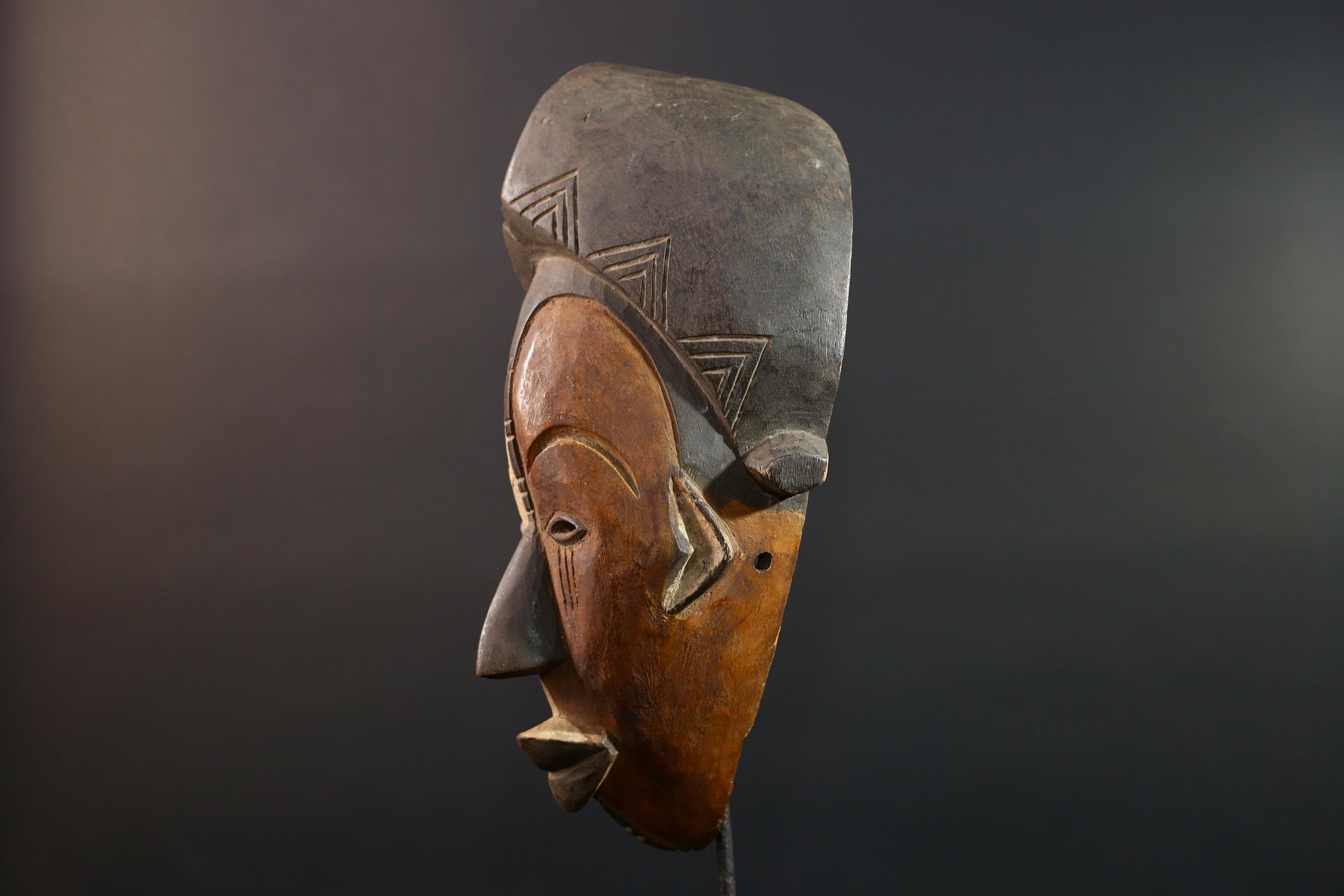 Hand carved African Punu mask tribal wall decor with kaolin white face and tall braided crest art from Central Africa G5569