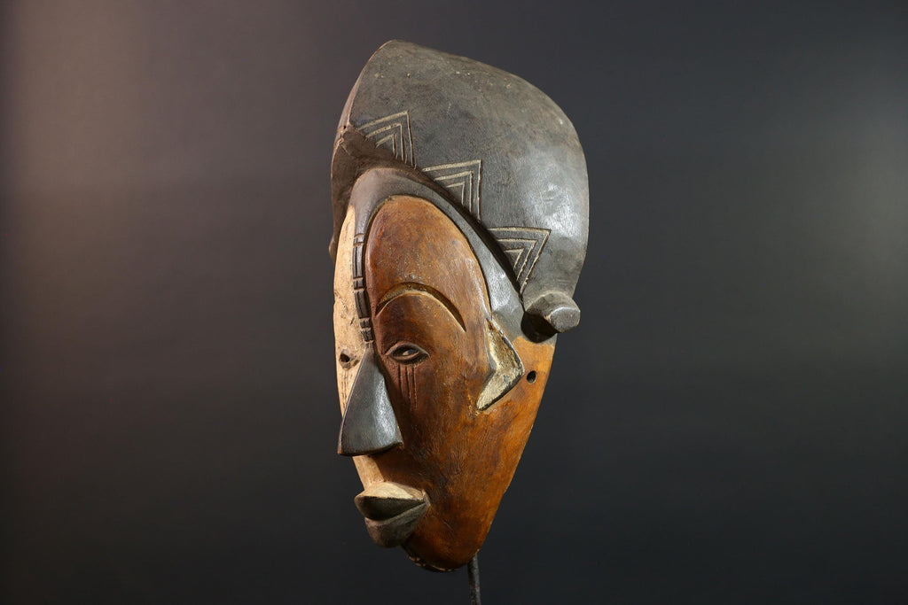 Hand carved African Punu mask tribal wall decor with kaolin white face and tall braided crest art from Central Africa G5569
