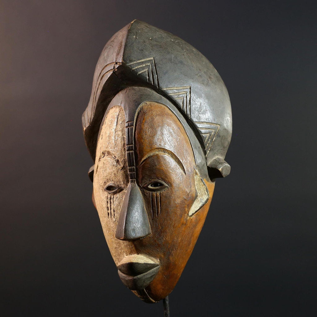 Hand carved African Punu mask tribal wall decor with kaolin white face and tall braided crest art from Central Africa G5569