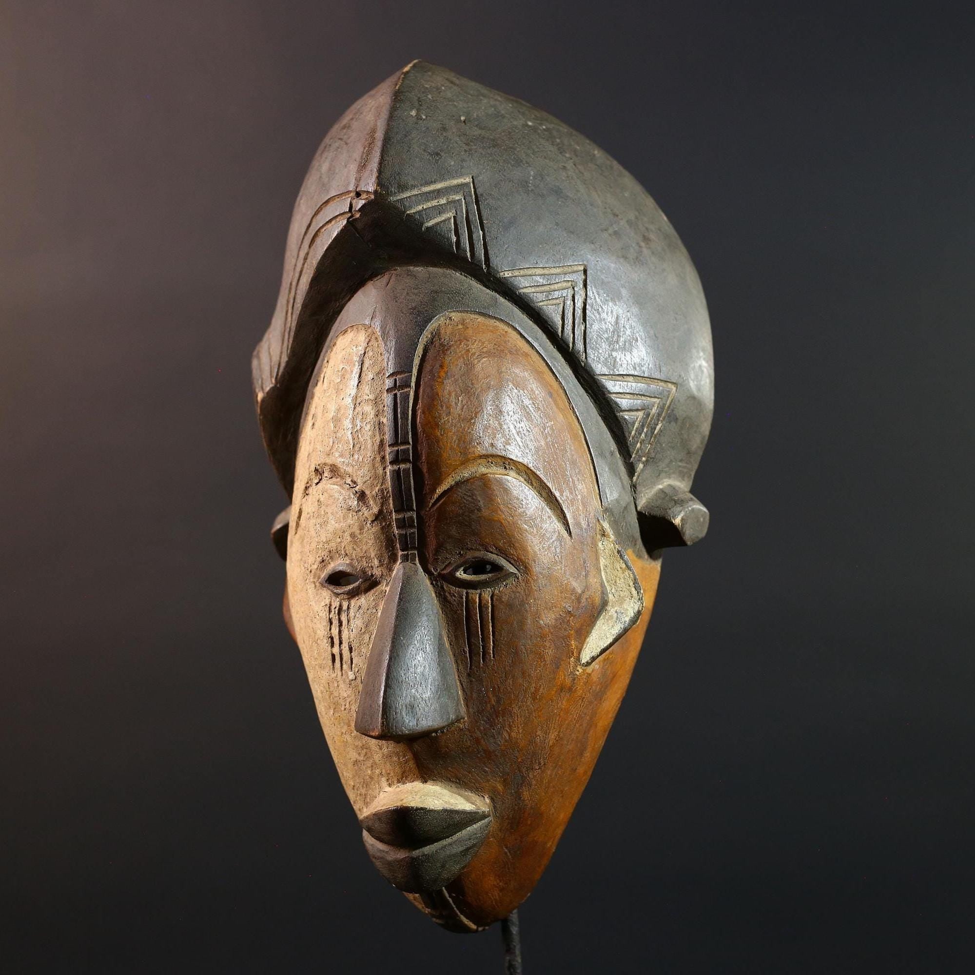 Hand carved African Punu mask tribal wall decor with kaolin white face and tall braided crest art from Central Africa G5569