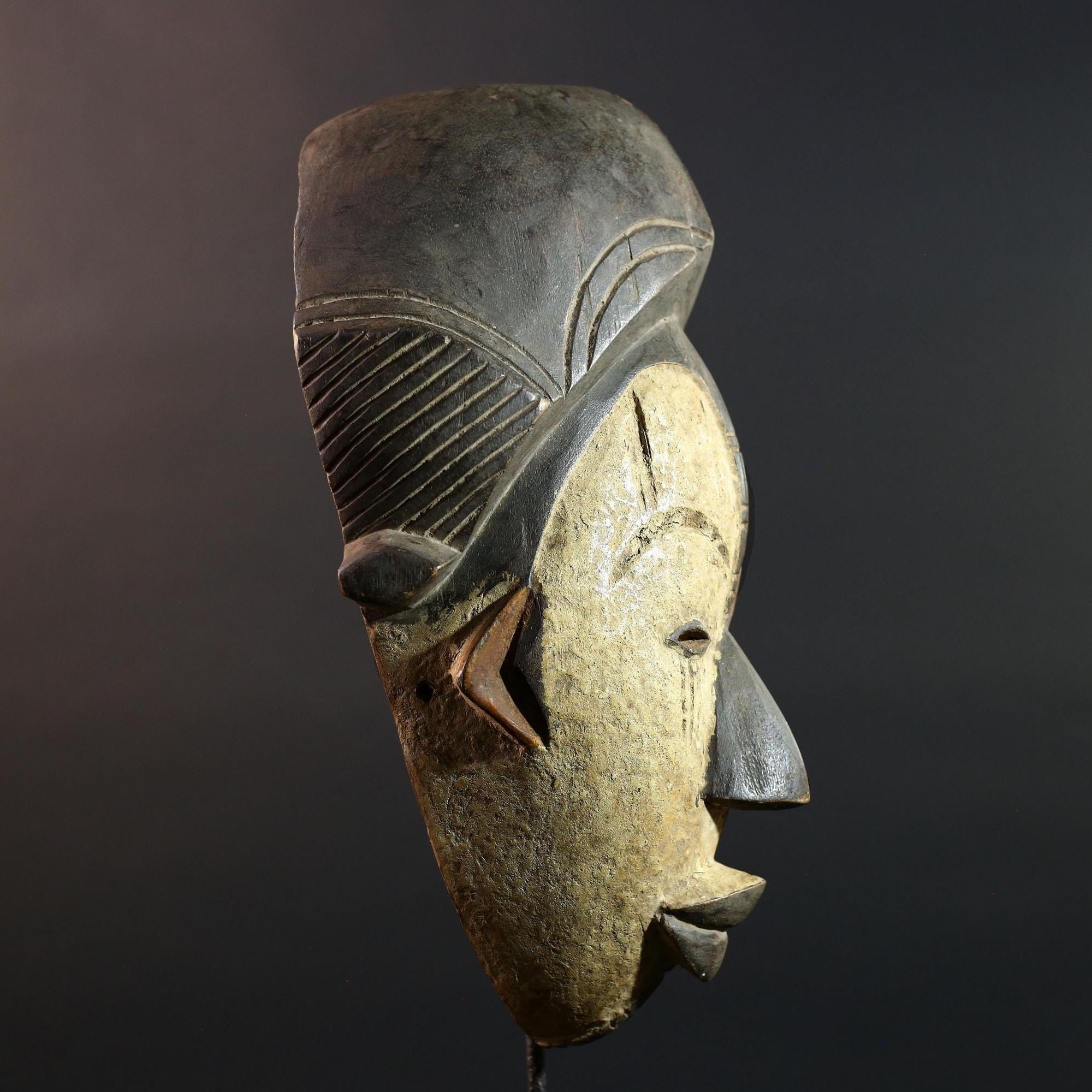Hand carved African Punu mask tribal wall decor with kaolin white face and tall braided crest art from Central Africa G5569