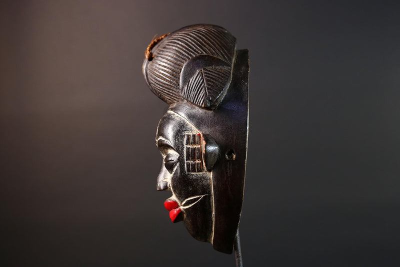 Punu tribal carving with red lips, black wood mask with fiber crest, ancestral spirit face art, African wall decor sculpture G5570
