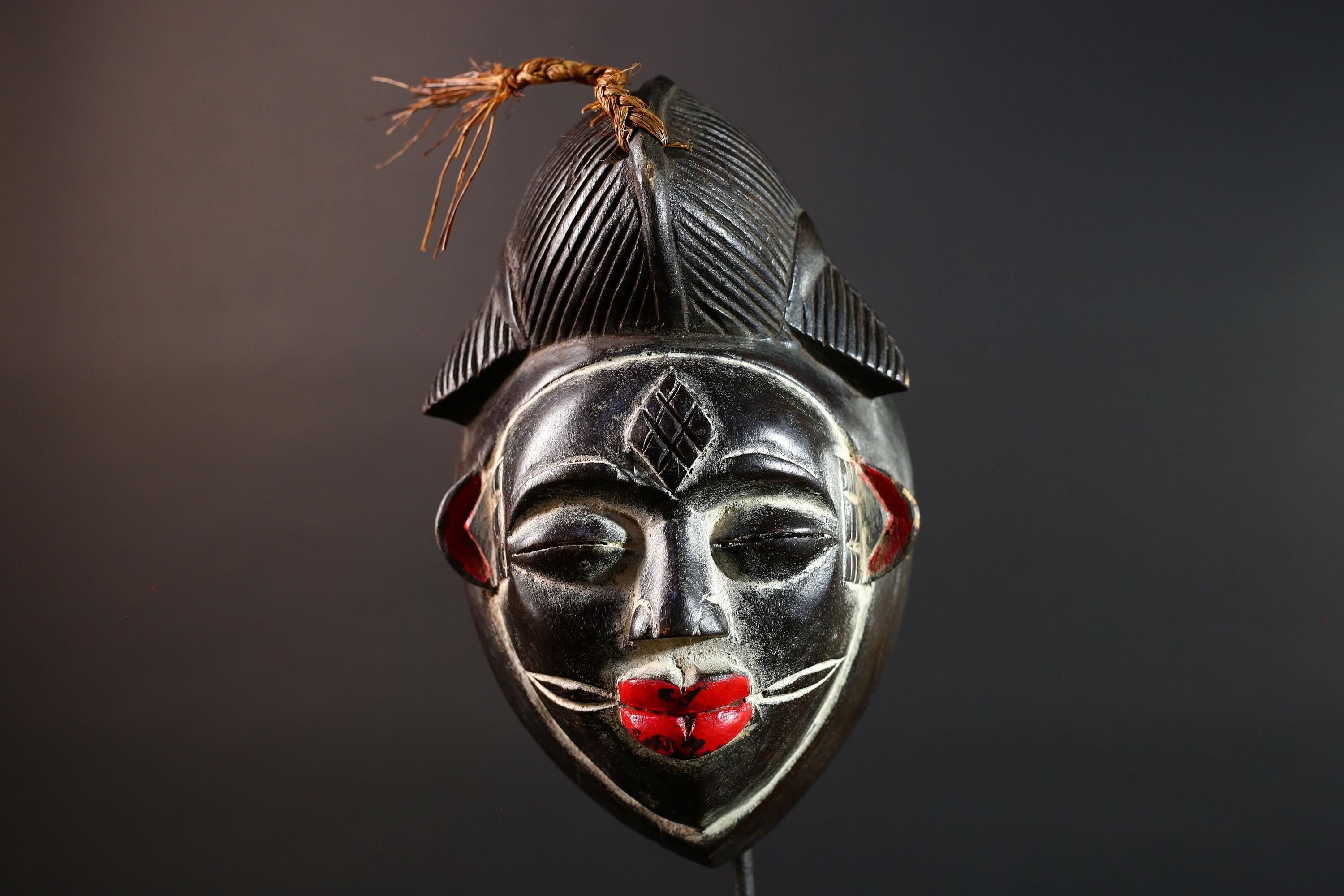 Punu tribal carving with red lips, black wood mask with fiber crest, ancestral spirit face art, African wall decor sculpture G5570