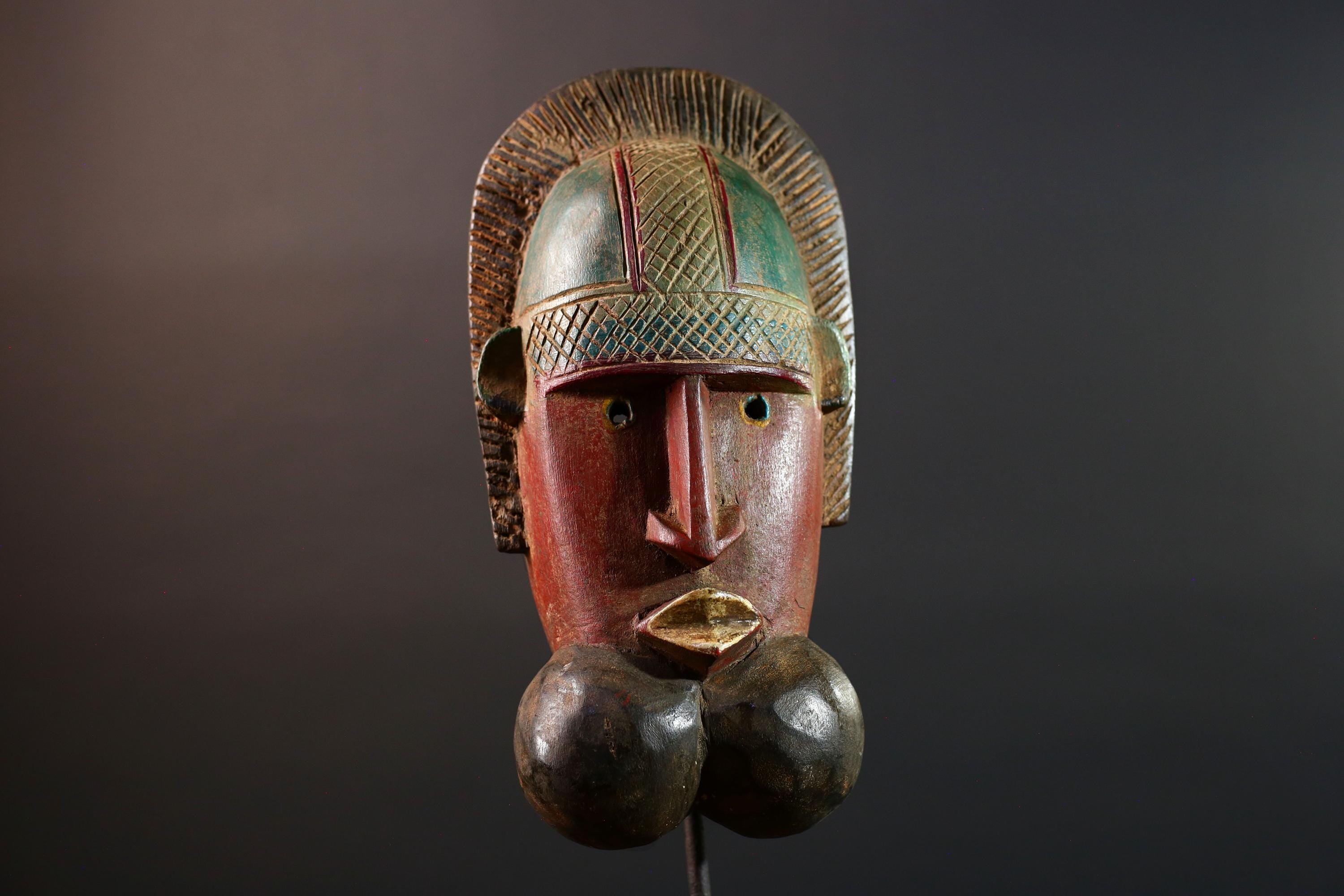 African mask Songye tribal decor with carved geometric features, red angular face, and bold cheek shapes wall hanging sculpture G5572