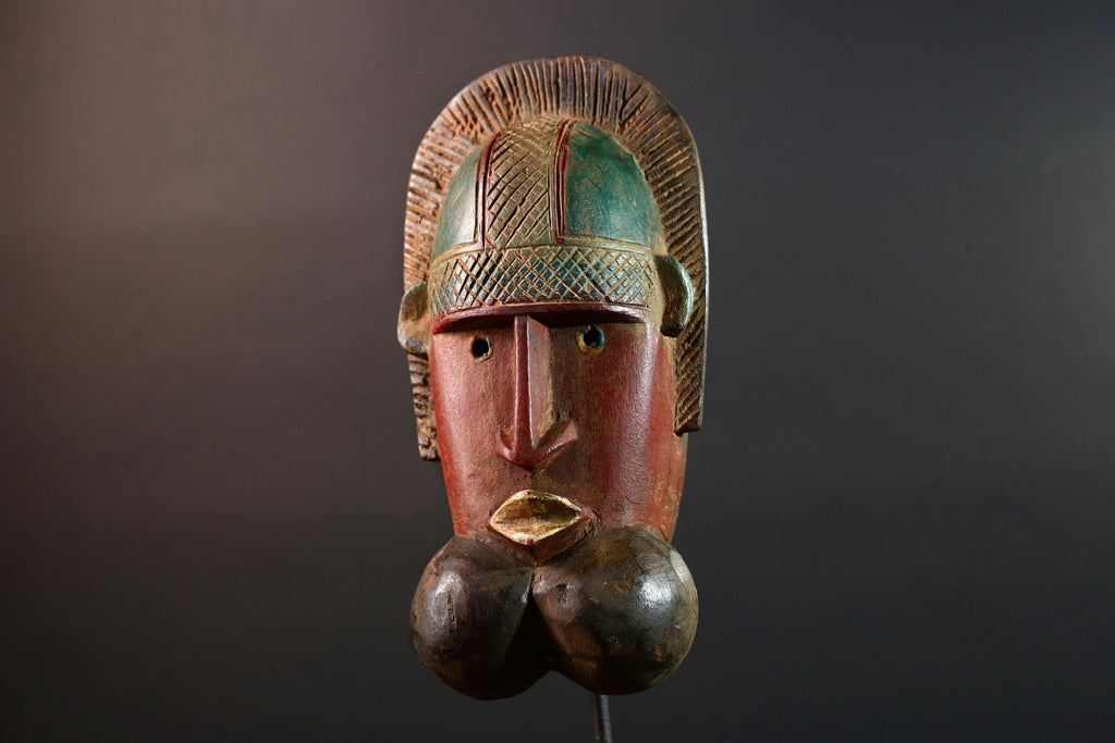 African mask Songye tribal decor with carved geometric features, red angular face, and bold cheek shapes wall hanging sculpture G5572