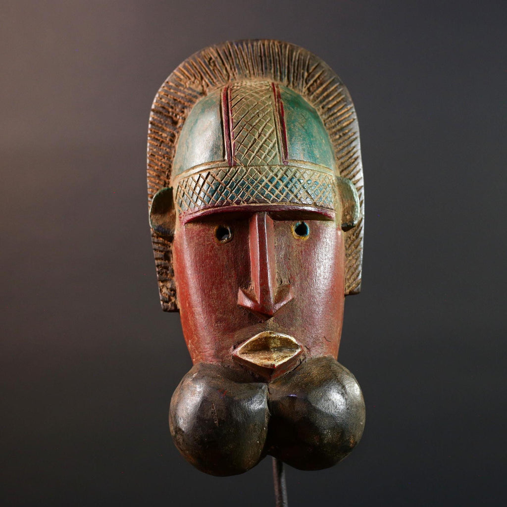African mask Songye tribal decor with carved geometric features, red angular face, and bold cheek shapes wall hanging sculpture G5572