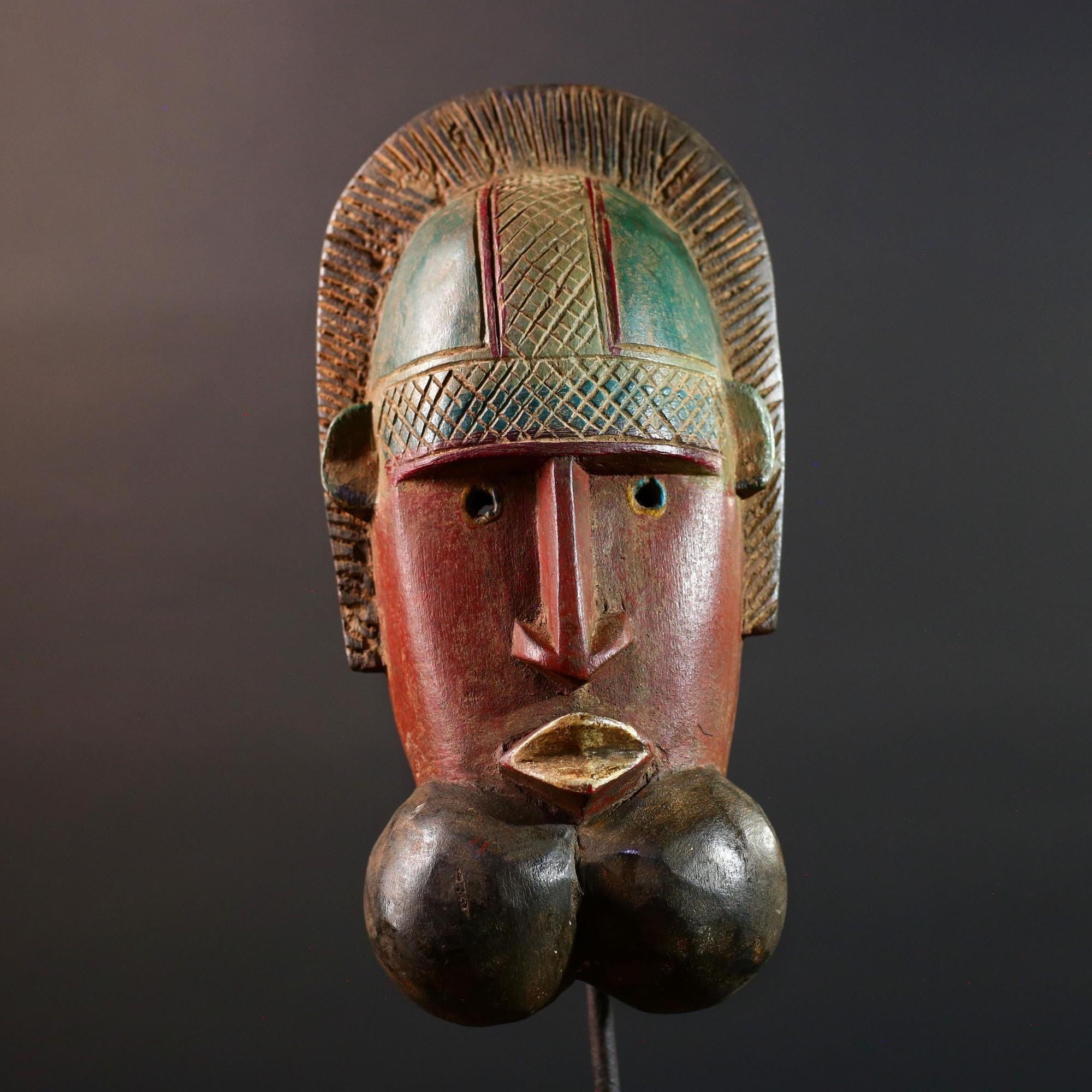 African mask Songye tribal decor with carved geometric features, red angular face, and bold cheek shapes wall hanging sculpture G5572