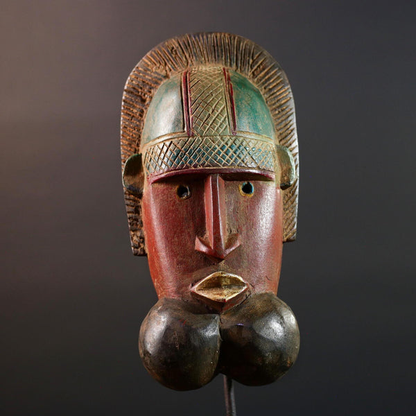 African mask Songye tribal decor with carved geometric features, red angular face, and bold cheek shapes wall hanging sculpture G5572