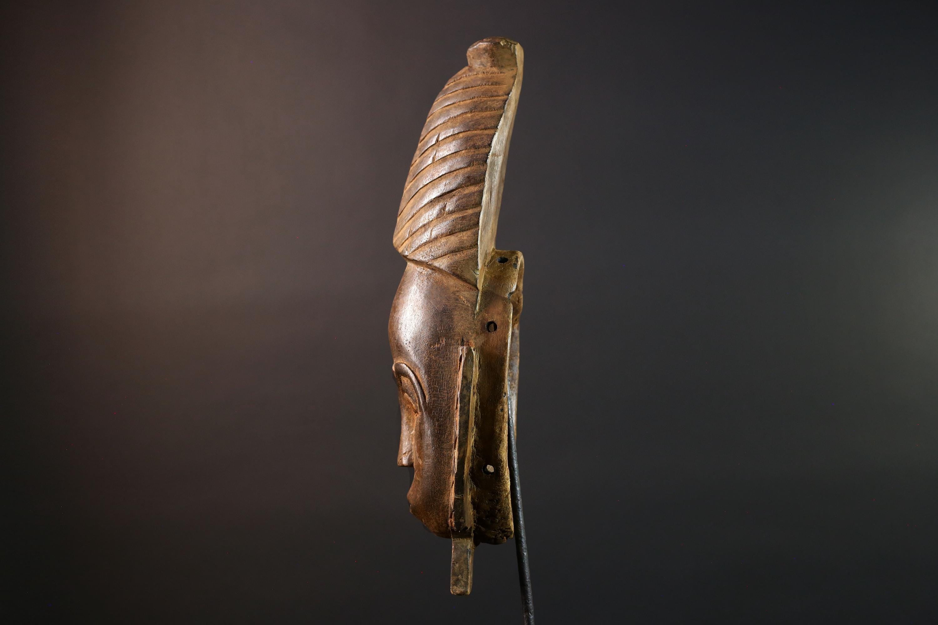 African mask Baule tribal art with long oval face, downcast eyes, vertical ridged crest, and carved cheek marks wall decor sculpture G5573