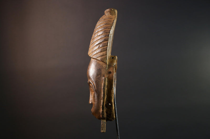 African mask Baule tribal art with long oval face, downcast eyes, vertical ridged crest, and carved cheek marks wall decor sculpture G5573