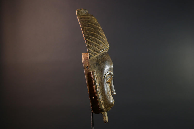African mask Baule tribal art with long oval face, downcast eyes, vertical ridged crest, and carved cheek marks wall decor sculpture G5573