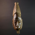 African mask Baule tribal art with long oval face, downcast eyes, vertical ridged crest, and carved cheek marks wall decor sculpture G5573