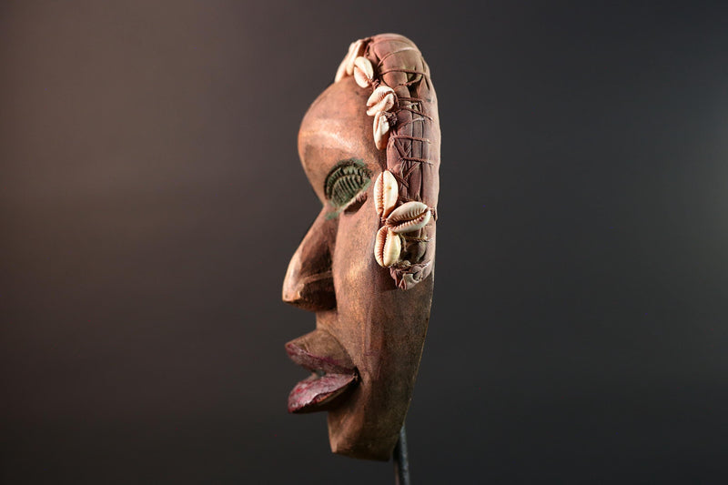African mask Dan cowrie headdress with green eyelids, red lips, and carved wood female spirit face from Côte d’Ivoire wall art G5575
