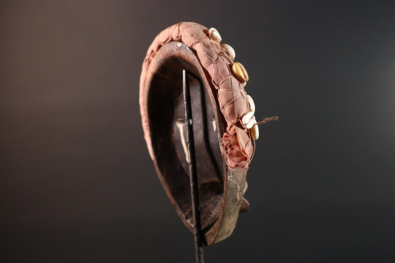 African mask Dan cowrie headdress with green eyelids, red lips, and carved wood female spirit face from Côte d’Ivoire wall art G5575