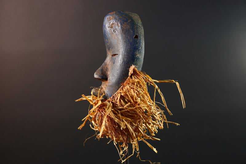 African mask Dan blue face with raffia fringe, slitted eyes, tribal carving from Côte d’Ivoire for ceremonial wall art or decor G5576